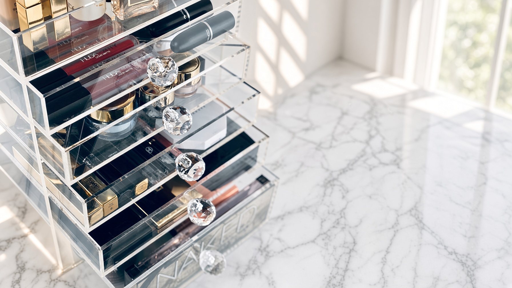 A MOBOX acrylic organizer with crystal handles on a marble vanity